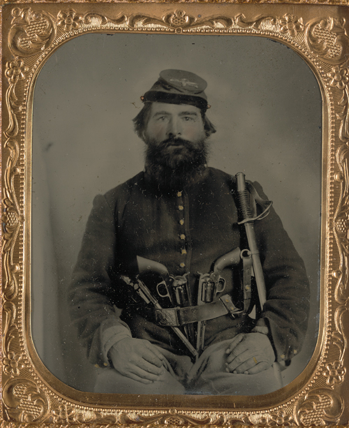 A. J. Blue was a cavalry trooper in the Union Army during the American Civil War (1861-1865). On this photo he poses with three Remington revolvers and a sabre (Library of Congress).