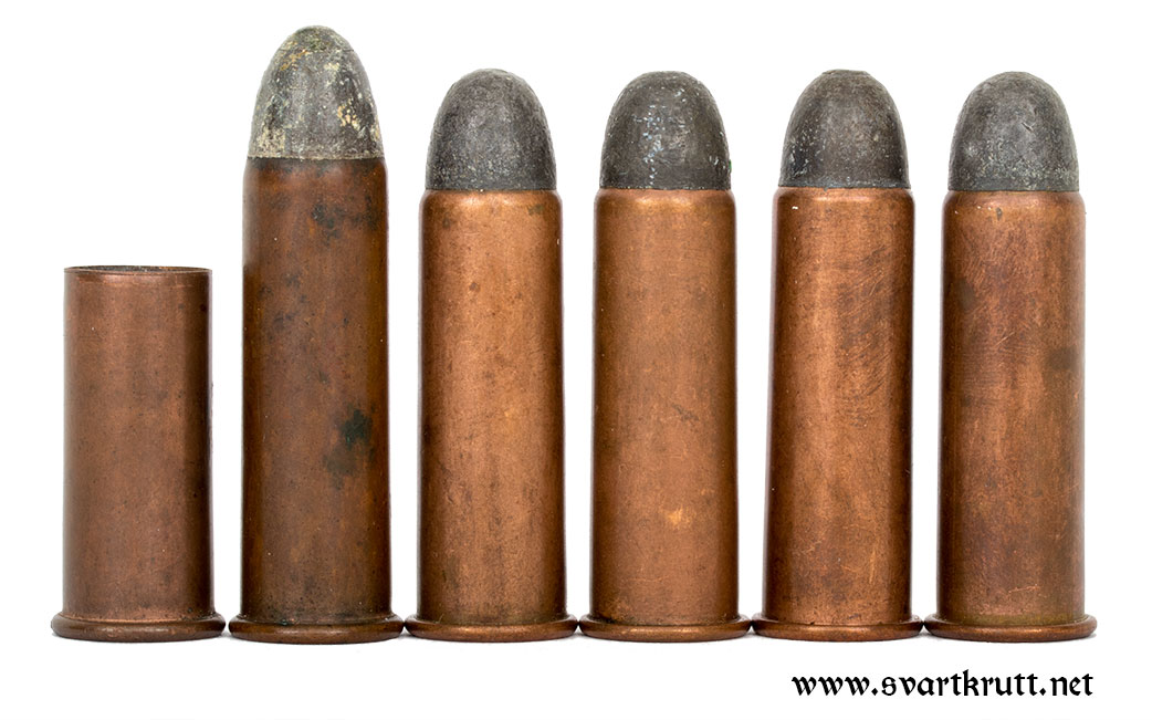Original military 12mm Remington ammunition. From left to right: Case for blank cartridge, Norwegian cartridge with 44mm long case and four Swedish cartridges with 40.7mm cases.